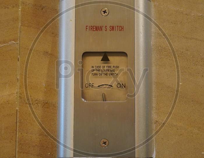 Closeup Of A Sign Stating "Fireman Switch" On A Hotel Lobby Wall And A Fire Switch Board. Fireman Lift Switch With Beautiful Background.