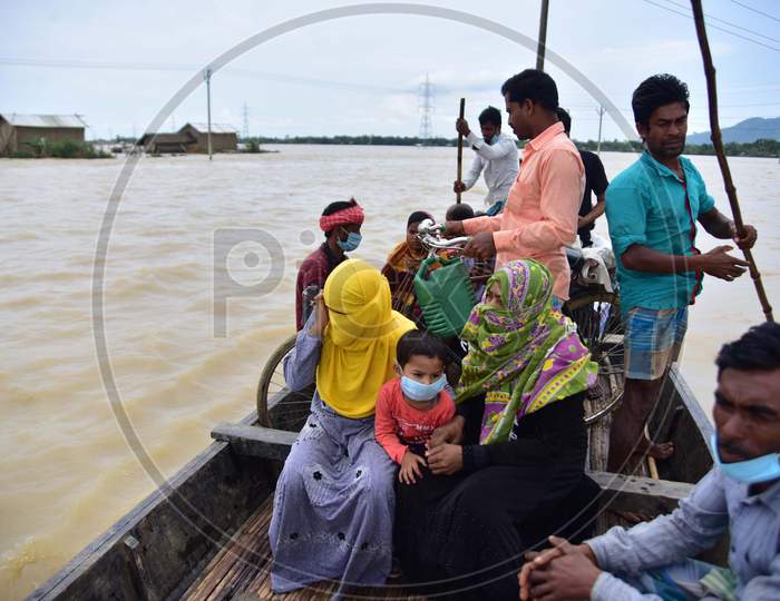 Flood Affected Villagers Are Transported on A Boat To A Safer Place In Hojai District, Assam On May 30,2020.