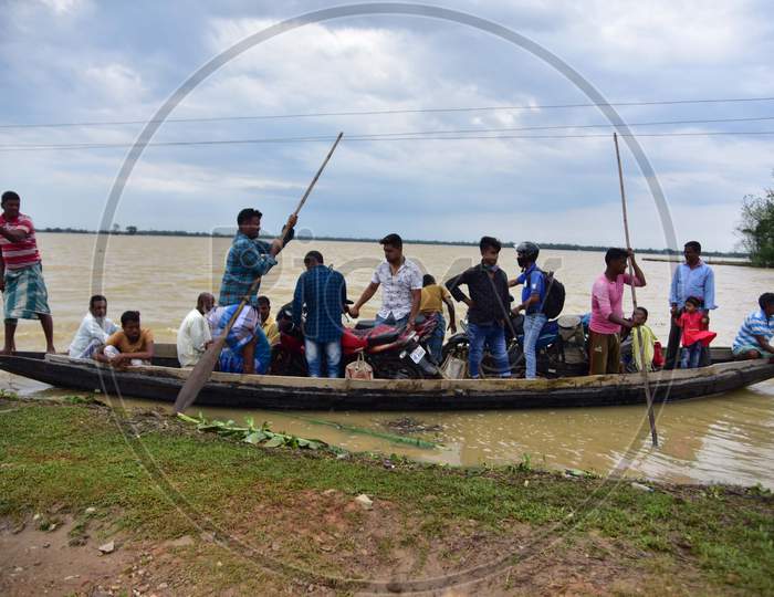 Flood Affected Villagers Are Transported on A Boat To A Safer Place In Hojai District of Assam On May 30,2020