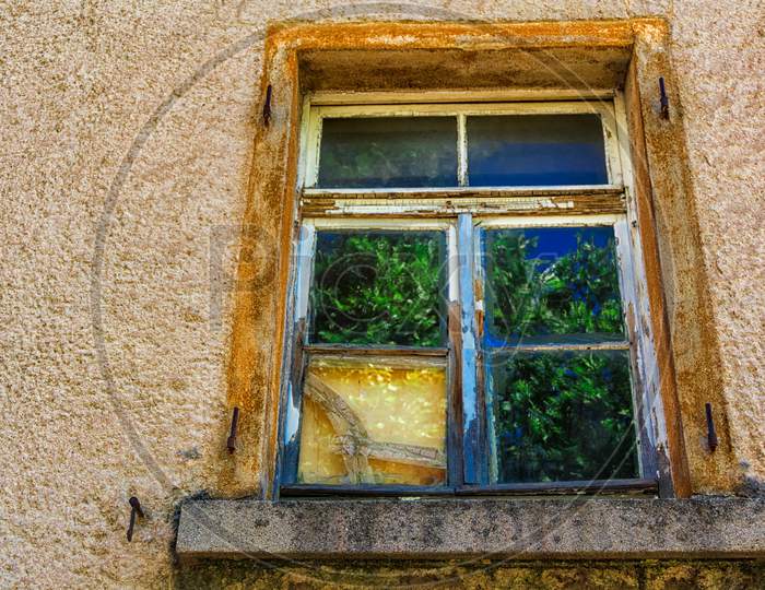 A Reflecting Window Of An Old House