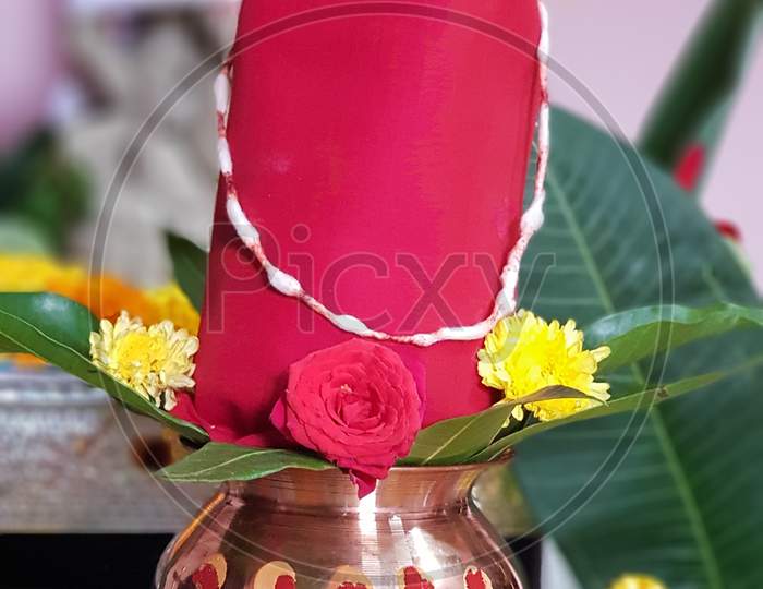 Copper Kalash with coconut and mango leaf with floral decoration on a white background. essential in hindu puja