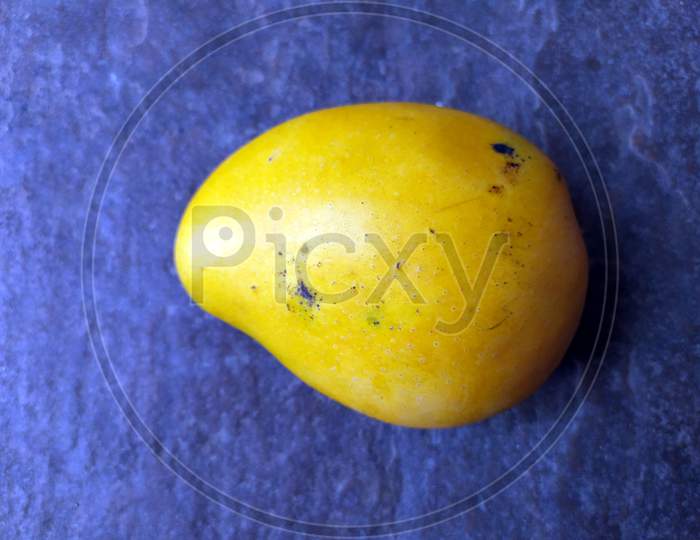 fresh sweet yellow mango isolated on stone background
