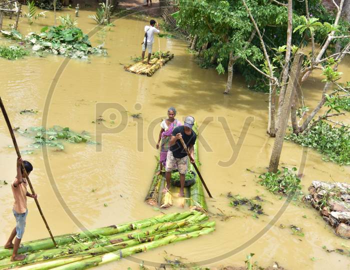 People Row A Makeshift Raft  At A Flood-Affected Village In Hojai District Of Assam On May 30,2020.