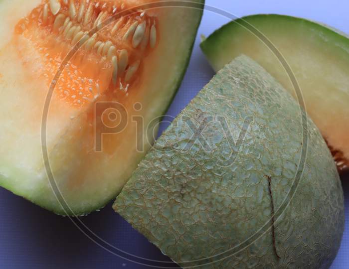 Full and Sliced Cantaloupe Isolated on White Background