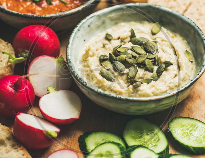 Vegetarian Dips Hummus, Babaganush, Muhammara Over Wooden Background