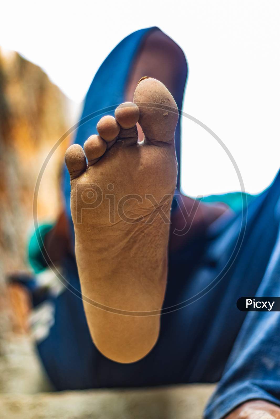 Men Feet Foot Legs On Low Angle Frame. Foot Pain. Men Sitting And Show Painful Foot. Having Painful Feet And Stretching Muscles Fatigue To Relieve Pain. Health Concepts. Human Foot With Leg Fingers.