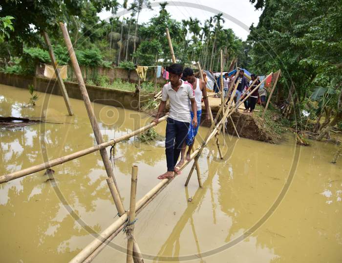 Villagers Use A Makeshift Bamboo Bridge After A Road Washed Out By Flood Water In Hojai District Of Assam On May 30,2020.