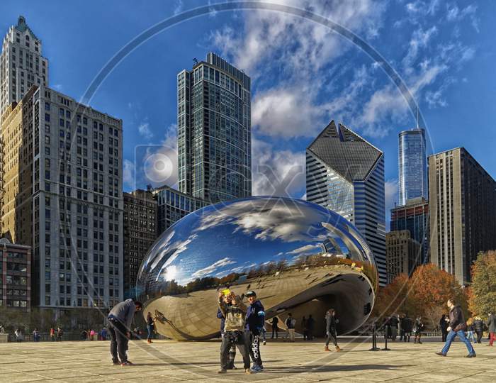 Cloud Gate (The bean) at Millennium Park , Chicago with skyline in the background Daylight view.
