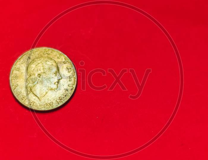 Italian 200 Lire Coin.Back Side Of Old Used Two Hundred Italian Lire, 1983. Vintage Bronze Coin Isolated On Red Background With Space For Text Copy. Repvbblica Italiana 200