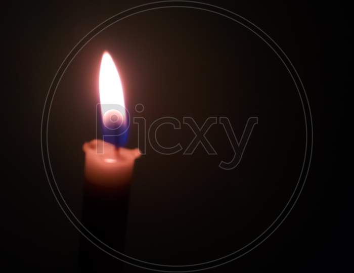 Candle light in darkness corona virus tragedy