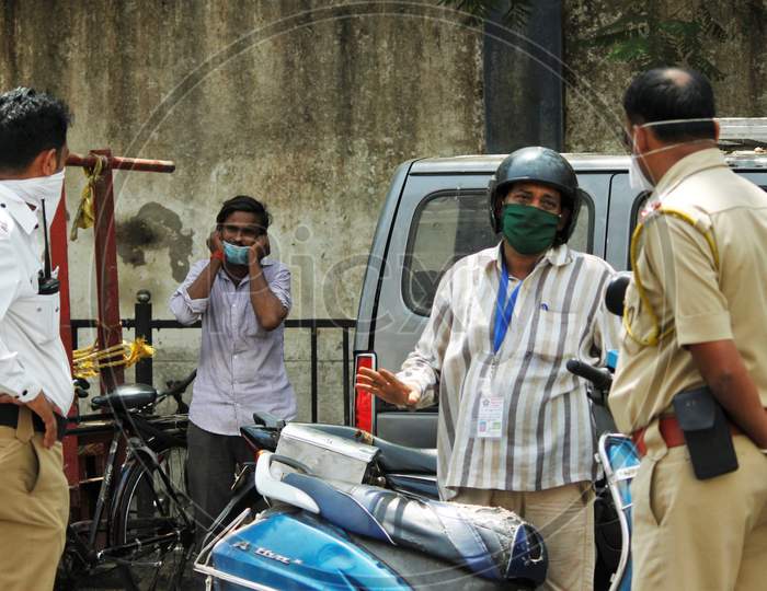 Police personnel are seen inquiring people coming out during a 21- day nationwide lockdown to limit the spreading of coronavirus disease (COVID-19) in Mumbai, India, on April 10, 2020.