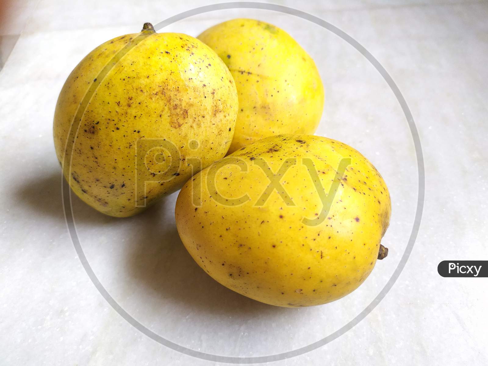 Whole mangoes on floor.
