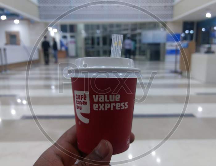 New Delhi, India - March 25, 2019 : Cafe Coffee Day Coffee With Little Straw Pipe In Hand
