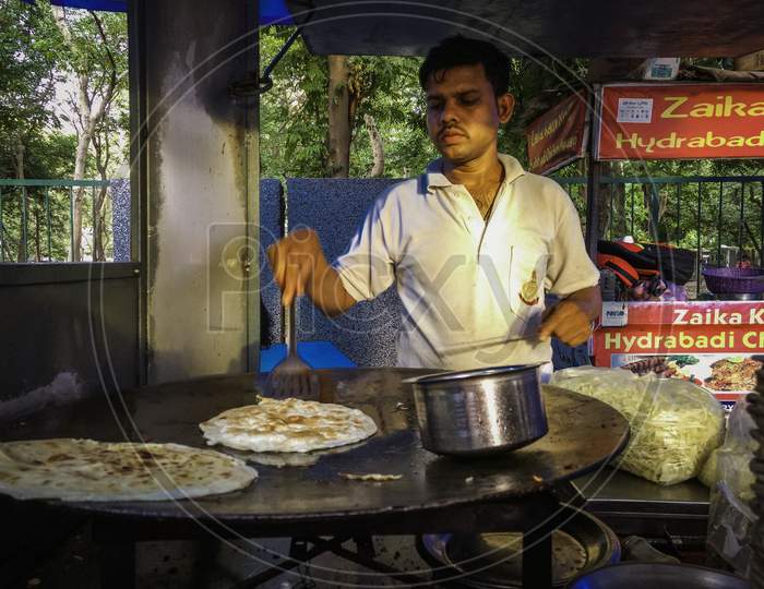 Delhi, India - Jan-25, 2020 : Roti Making, Roti Thresh Flour By Roti Maker With Oil. Indian Traditional Street Food. Thai Pancake Banana And Egg, Selective Focus