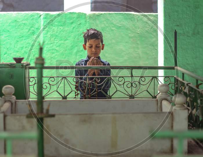 New Delhi, Delhi/ India- May 31 2020: A Small Kid Reading Morning Namaz Near A Darga In Jama Masjid.