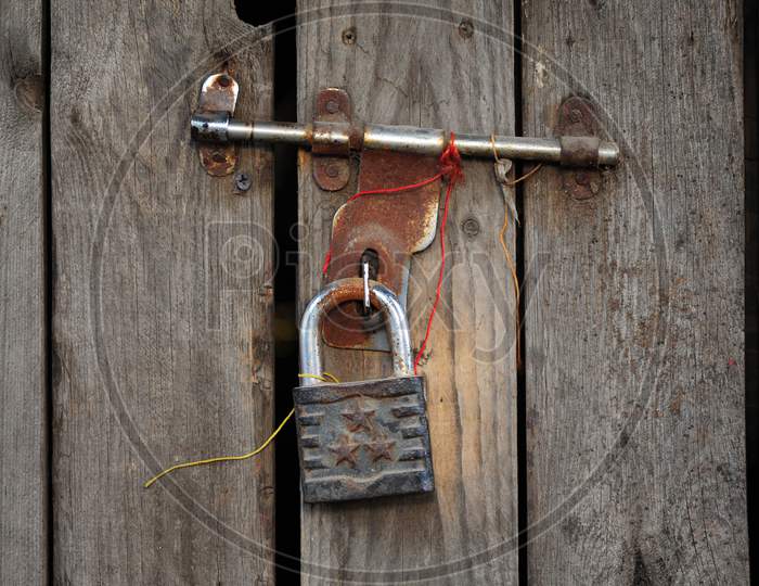 Iron padlock on a rusty latch