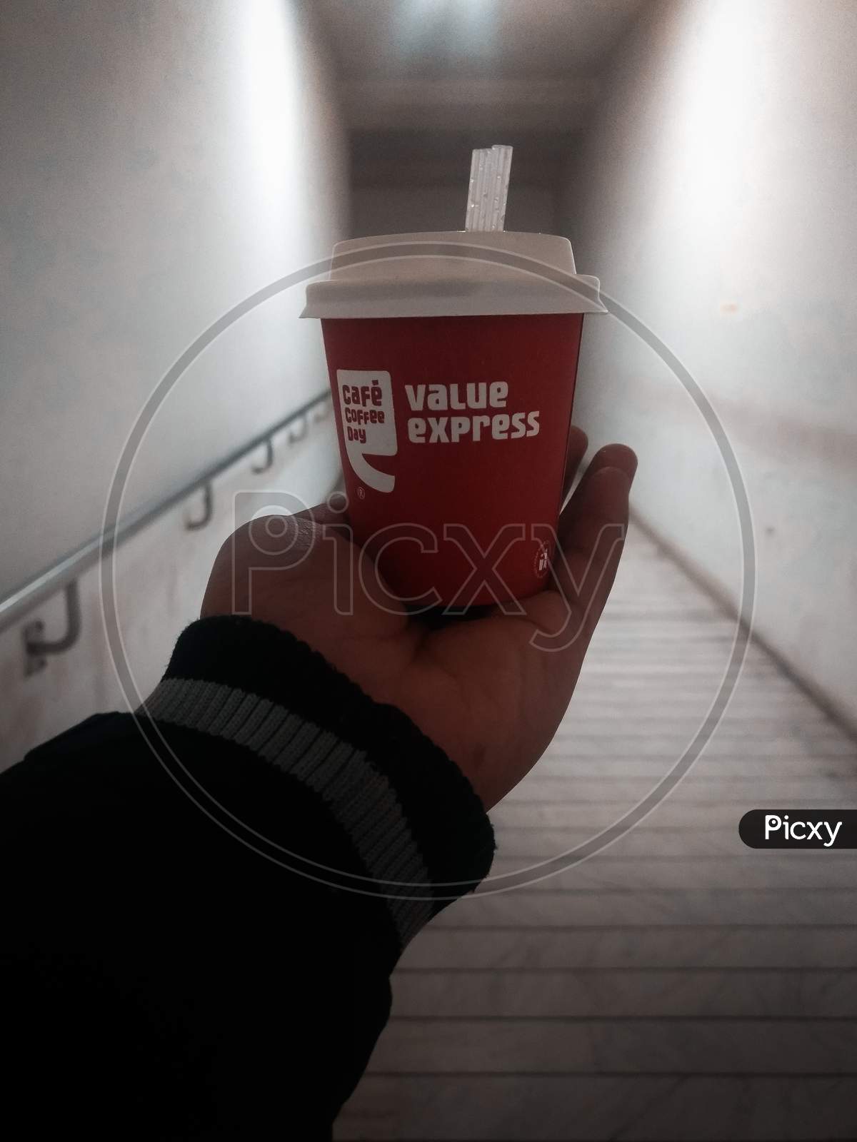 New Delhi, India - March 25, 2019 : Cafe Coffee Day Coffee With Little Straw Pipe In Hand