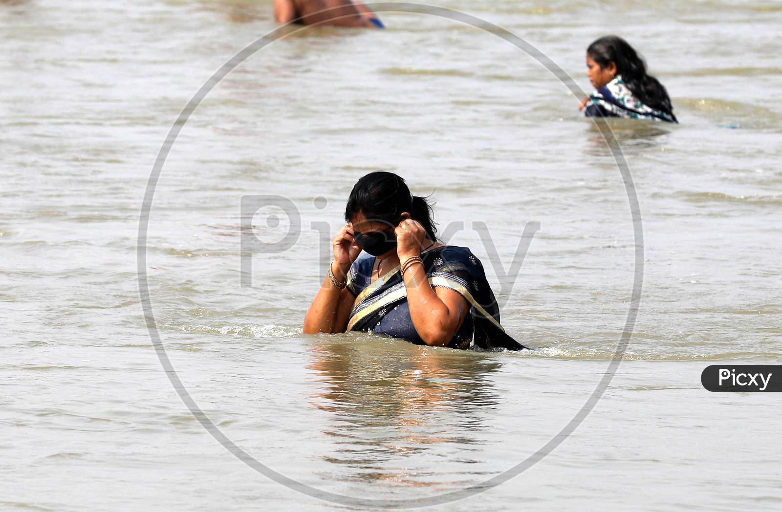 A Hindu Woman Devotee Taking a Holy Dip In Ganga River In Prayagraj on May 31, 2020
