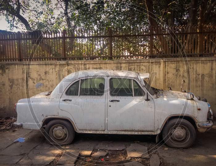 New Delhi, India - April 25, 2019. A Beige Vintage White Ambassador Car Is Parked On A Street