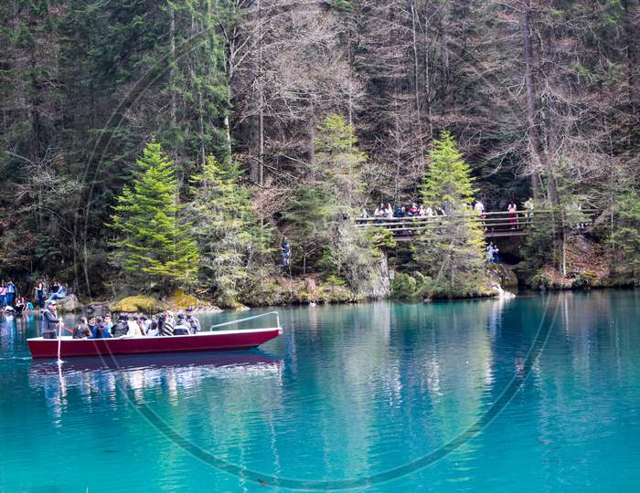 Interlaken / Switzerland - April 20, 2019 : Tourist boating in lake Blausee- An unbelievable view with breathtaking  landscape. It is one of the favorite picnic tourist spot for locals