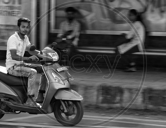 Delhi, India - 17 February 2019: Riding On A Activa Scooty (Blurred Motion).