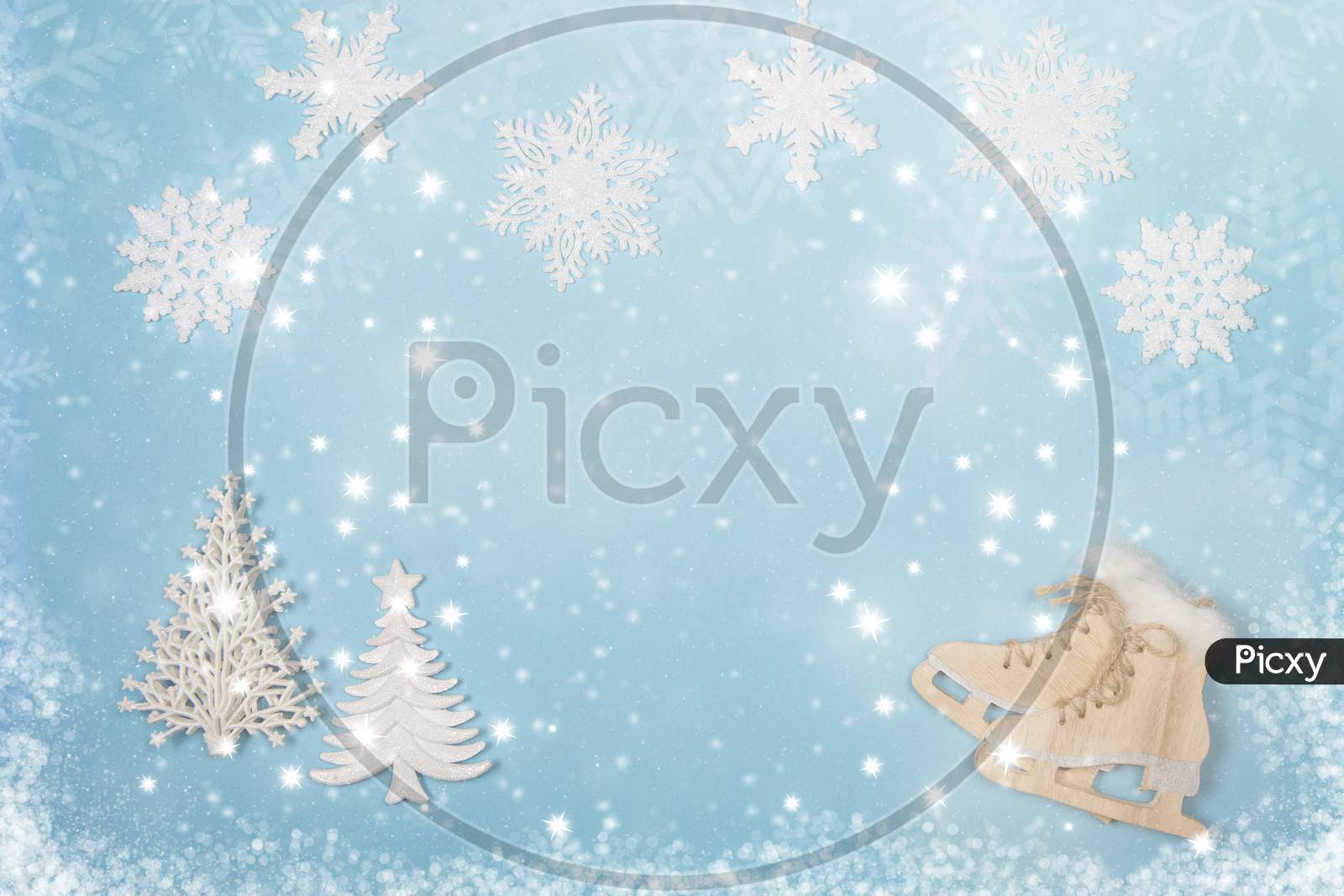 Winter Seasonal Flatlay With The Ice Skates And Christmas Trees On A Blue Background With And Snow And Snow Flakes