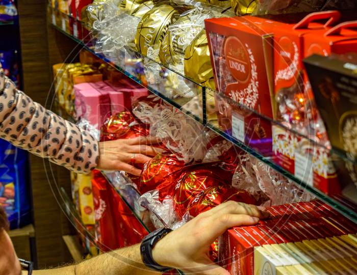 Interlaken, Switzerland - April 20, 2019: People biying chocolate from retail store during winters. Lindt is one of the most famous chocolate of European Origin