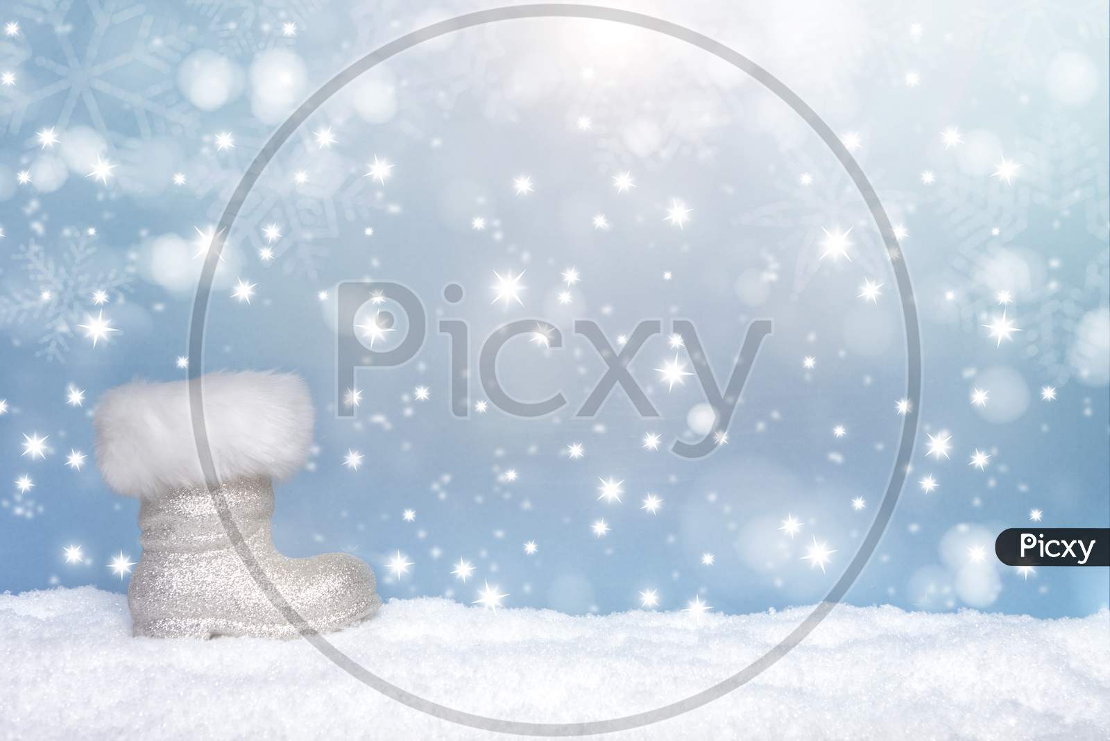 Winter Seasonal Background With The Boot Of Santa And Snow And Snow Flakes