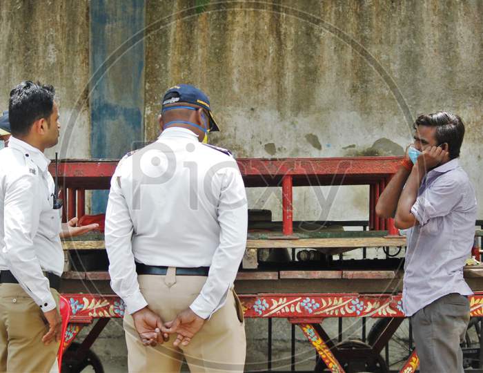 A man pleads to the policemen after he was held up for violating the lockdown rules during a 21- day nationwide lockdown to limit the spreading of coronavirus disease (COVID-19) in Mumbai, India, on April 10, 2020.