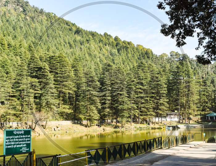Dharamshal, 2019: Tourist location in Dharamshla surrounded by dense trees and lake. A sign board telling about the location can also be seen