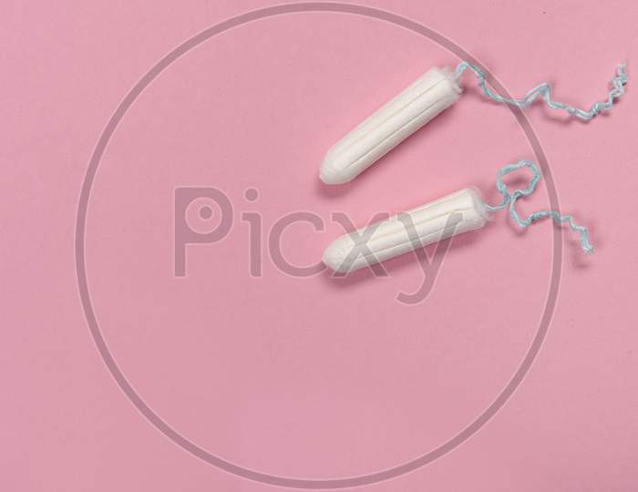 Two Tampons Seen From A High Angle View On A Pink Background With Space For Copy