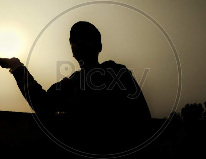 silhouette of a boy in evening