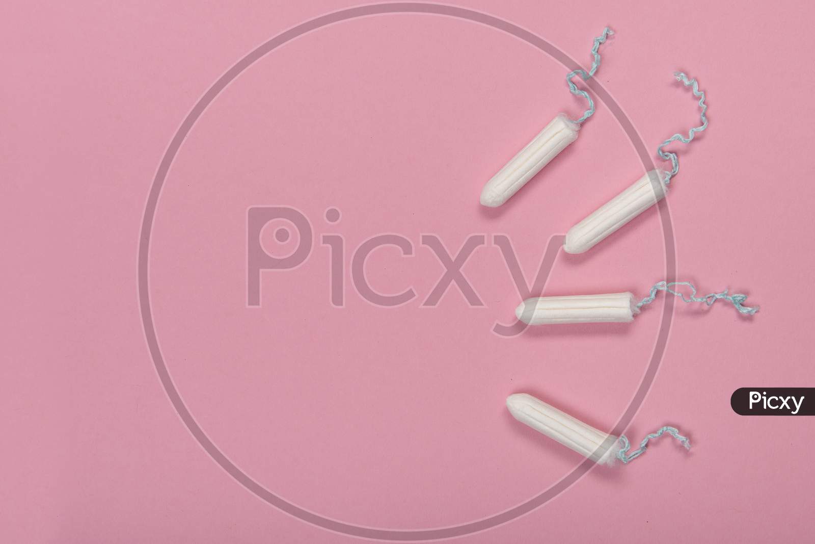 Group Of Tampons Seen From A High Angle View On A Pink Background With Space For Copy