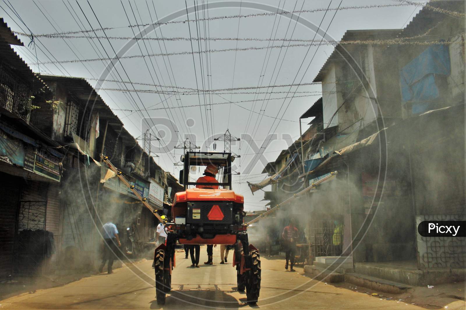 Fire personnel use an aerial mist blowing machine to spray disinfectant to decontaminate a street during a 21-day nationwide lockdown to limit the spreading of coronavirus disease (COVID-19) in Mumbai, India on April 12, 2020.