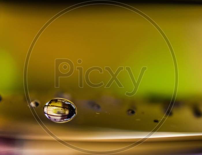crystal clear reflection of water drop on plane surface made spherical shape with blur background