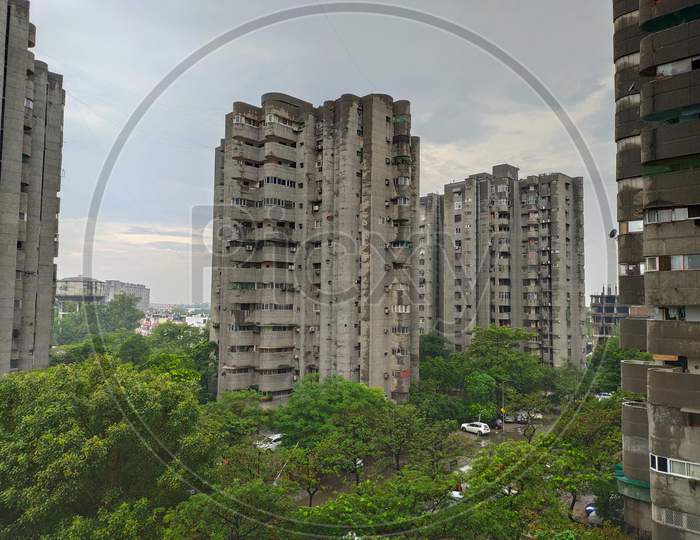 Ghaziabad, 2019: High rise grey color building in Kaushambi,  Ghaziabad surrounded by greenery