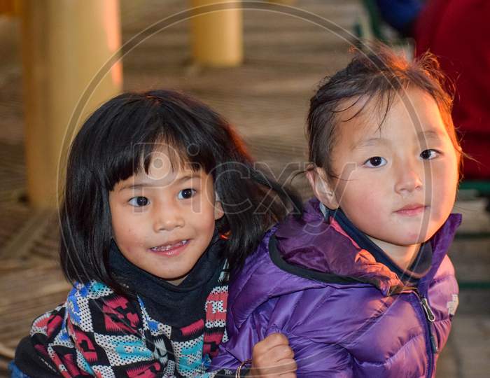 Dharamshala, India 2016 : Two Cute Chinese girls playing and posing for photographs. Images are captured in Dharamshala which is considered as a place of political asylum for Dalai Lama