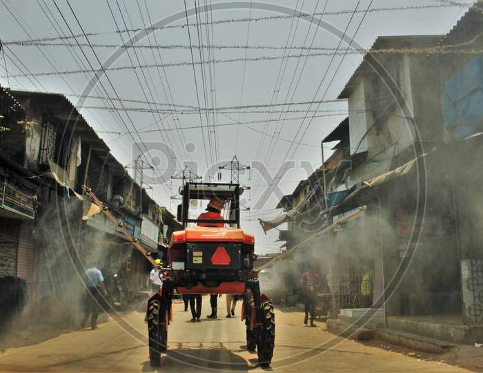 Fire personnel use an aerial mist blowing machine to spray disinfectant to decontaminate a street during a 21-day nationwide lockdown to limit the spreading of coronavirus disease (COVID-19) in Mumbai, India on April 12, 2020.