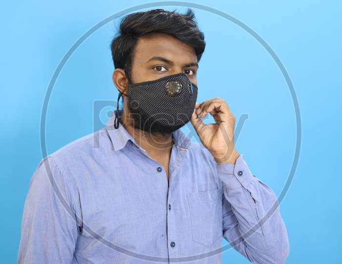 Indian man with a mask on sky background