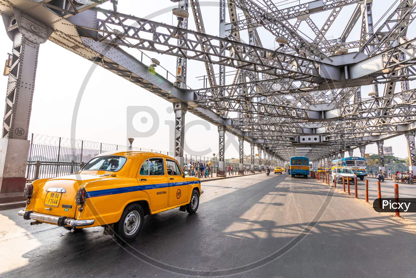 Yellow  Cab  Running On Howrah Bridge Background in Kolkata, West Bengal