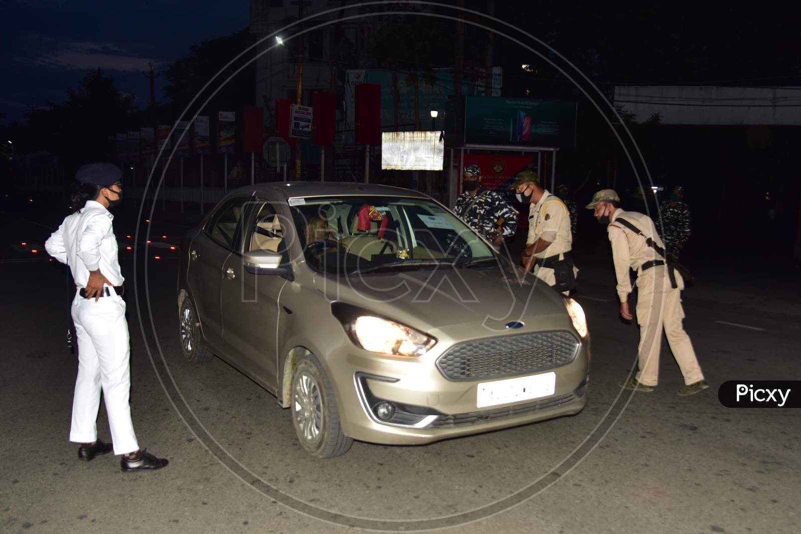 Security Personnel Question Commuters Who Defied Curfew In The Third Phase Of Covid-19 or Coronavirus Nationwide  Lockdown, In Nagaon District Of Assam On May 04,2020.