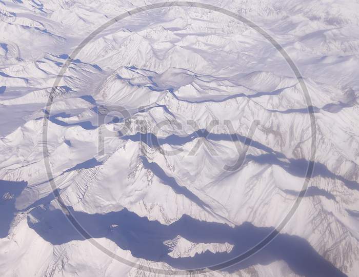 A view of the Ladakh Range of mountains as seen from a flight in winter, while landing at Leh, India