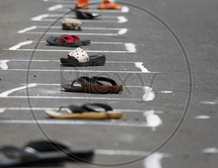 Pairs of slippers are left to secure spots in boxes drawn on a street to maintain social distancing during the nationwide lockdown to stop the spread of Coronavirus (COVID-19) in Bangalore, India, May 02, 2020.