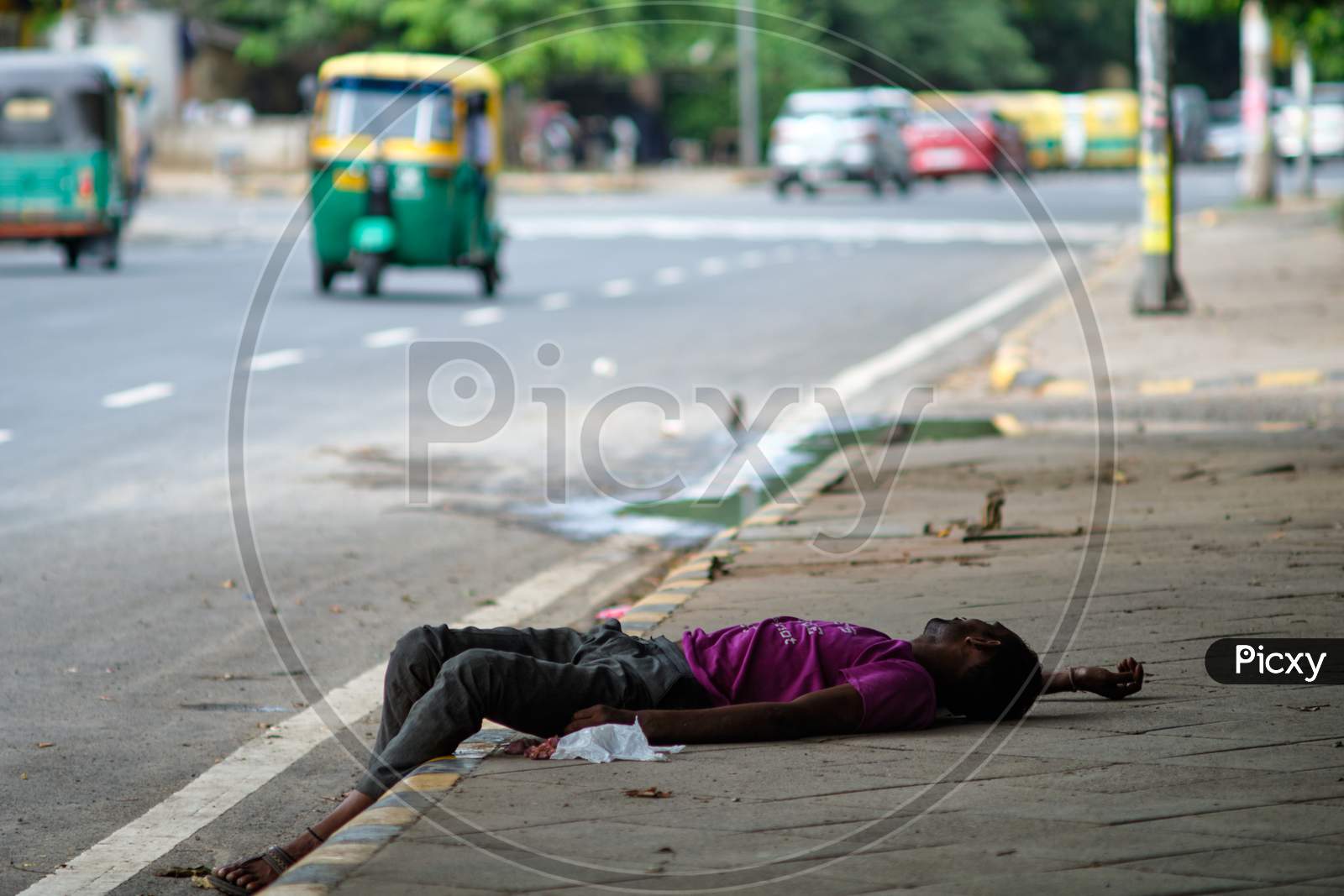 Poor Homeless Man Sleeping On Sidewalk In New Delhi, India