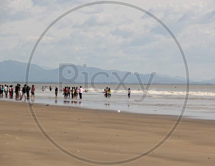 People Walking on the Seashore