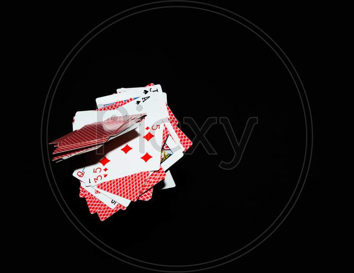 Falling playing cards seamless pattern isolated on black background.