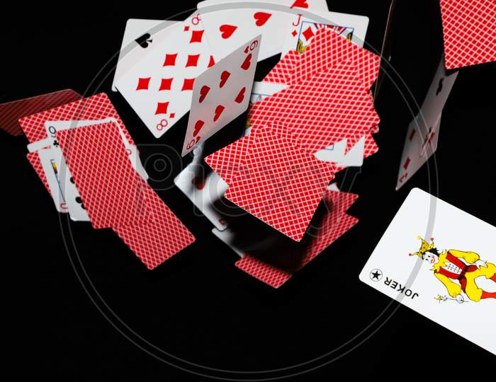 Falling playing cards seamless pattern isolated on black background.