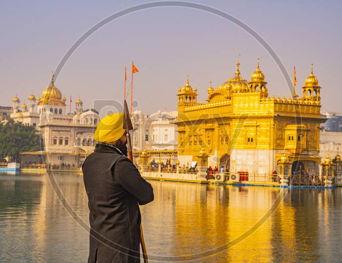 Sikh devotee as holy guard in the golden temple shri Harmandir Sahib in Amritsar, India Amritsar, Punjab, India