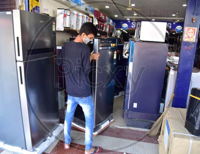 A Worker Arranges Electronic Items After Authorities Allowed Sale  With Certain Restrictions, During The Ongoing Covid-19 or Coronavirus  Nationwide Lockdown In Nagaon District Of Assam On May 04,2020
