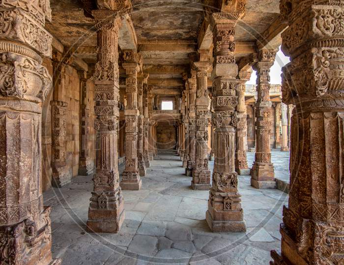Stone Carvings On The Cloister Columns At Quwwat Ul-Islam Mosque In Qutb Minar Complex, Unesco World Heritage Site In Delhi, India